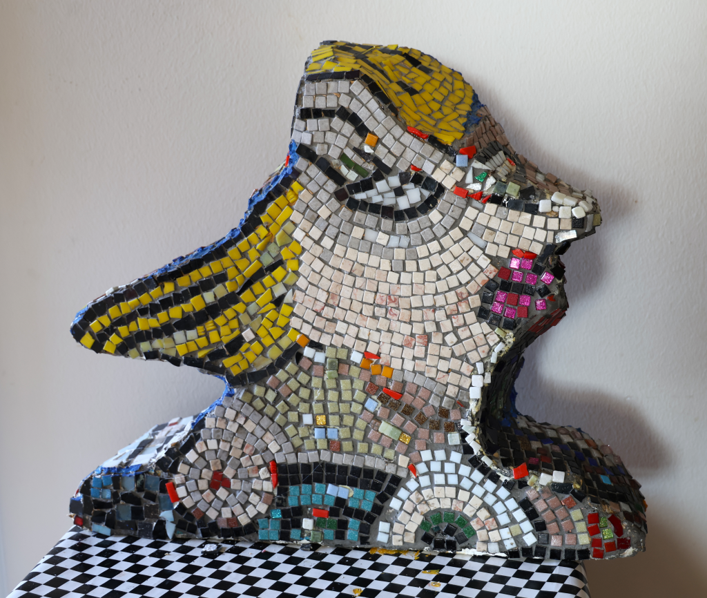 colorful mosaic work, presents sideprofile of a womans head.